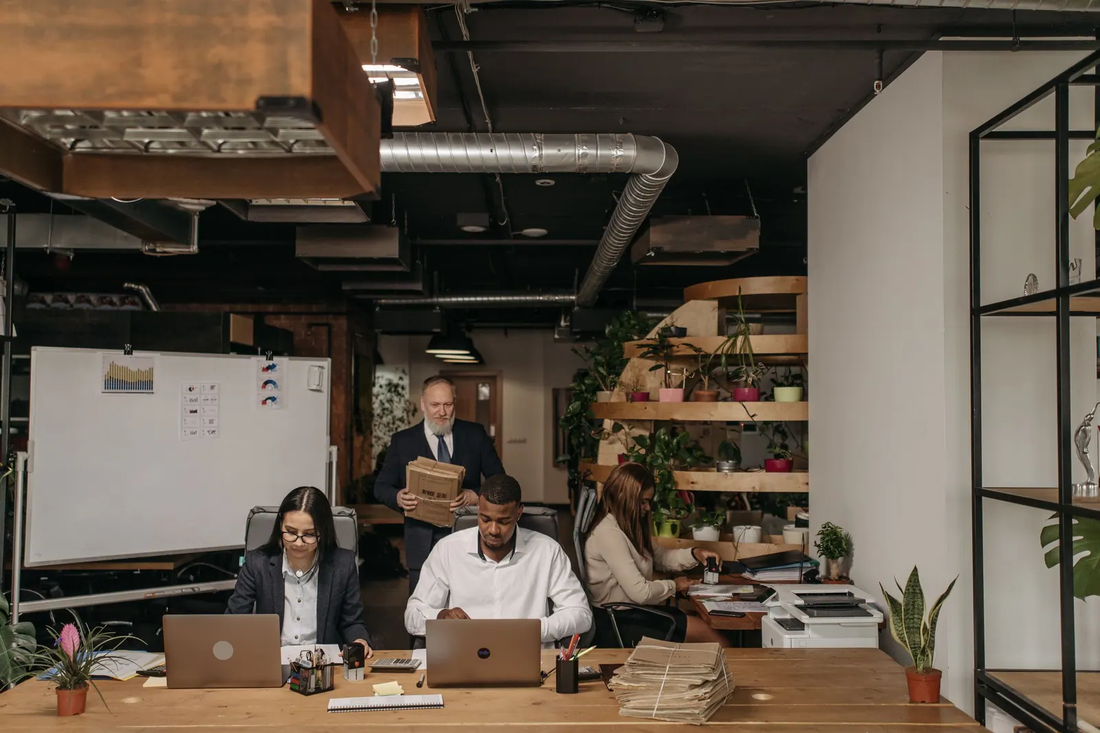 An open-plan office with a team at their desks